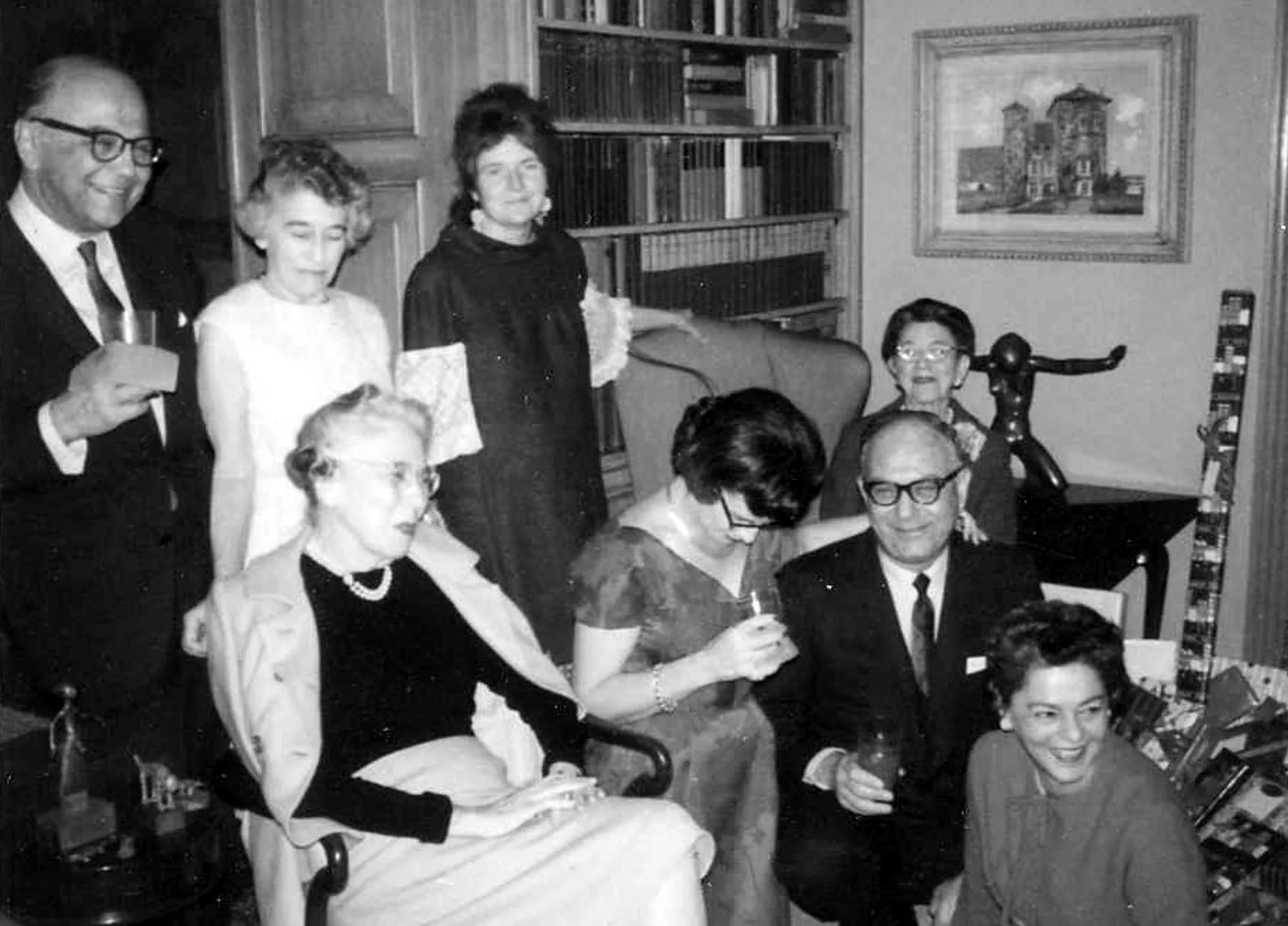 Family and friends gathered in a book-lined room