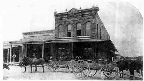 The Bromberg general store in Mineola, with wagons and horses out front